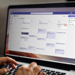 Charity staff working on a laptop, planning Microsoft 365 licence changes in calendar.